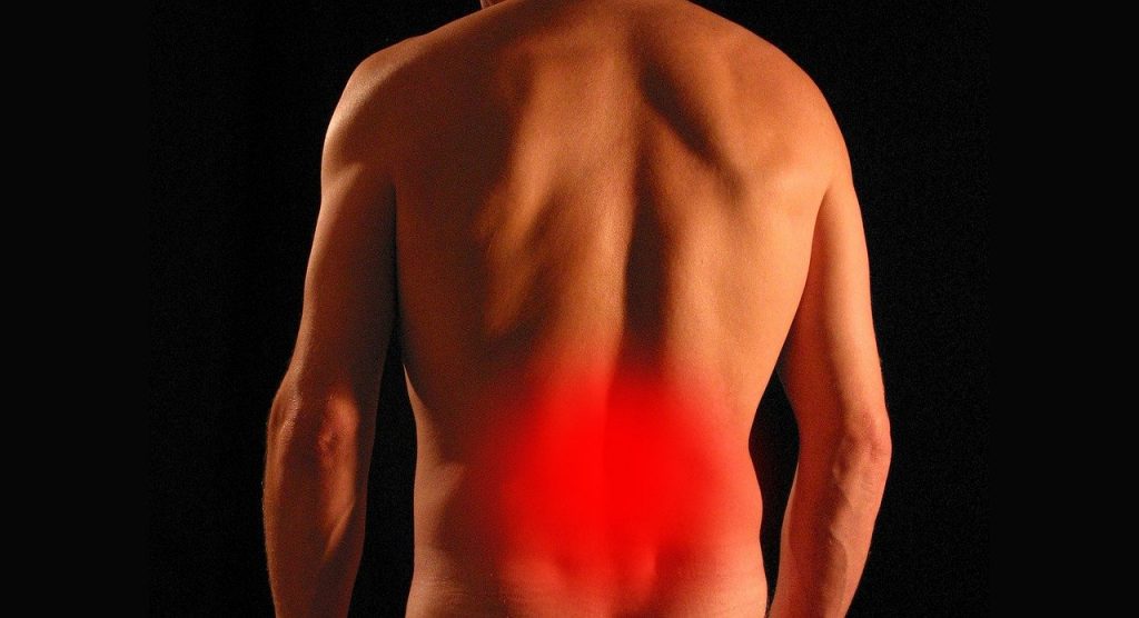 Point rouge, signifiant la douleur, situé au bas du dos d'un homme