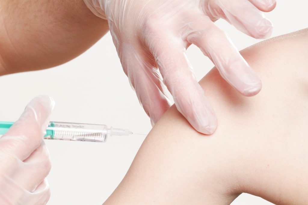 personnel médical injectant un vaccin à un patient